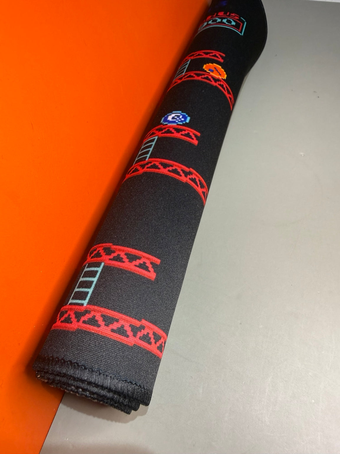 Donkey Kong desk mat rolled to show flexibility